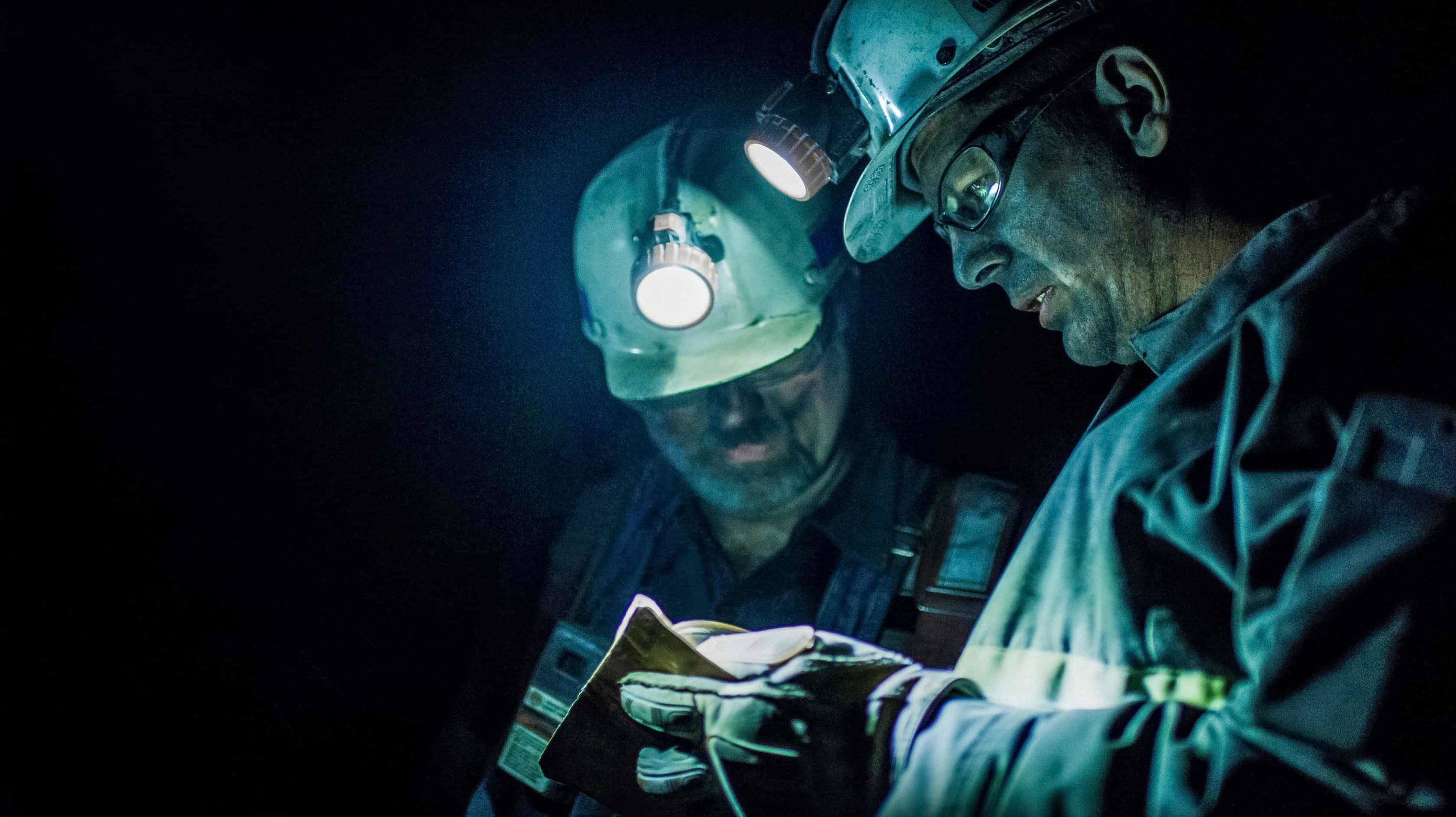 Miners Examining Something