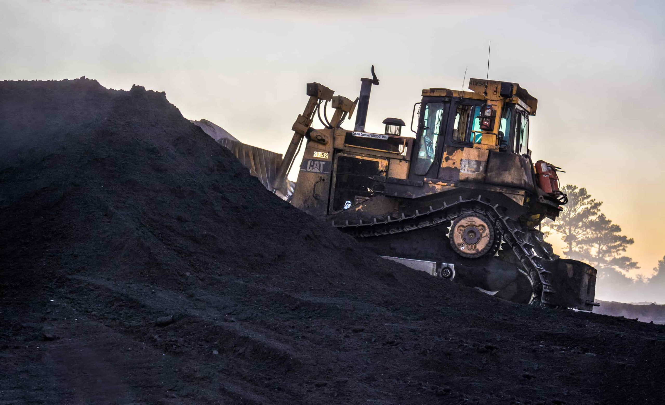 A bulldozer moving coal